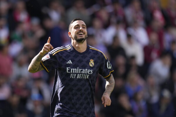 Real Madrid's Joselu celebrates after scoring his side's opening goal during the Spanish La Liga soccer match between Rayo Vallecano and Real Madrid at the Vallecas stadium in Madrid, Spain, Sunday, Feb. 18, 2024. (AP Photo/Manu Fernandez)