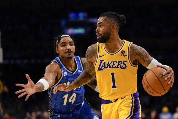 Orlando Magic guard Gary Harris, left, defends as Los Angeles Lakers guard D'Angelo Russell dribbles during the first half of an NBA basketball game, Monday, Oct. 30, 2023, in Los Angeles. (AP Photo/Ryan Sun)