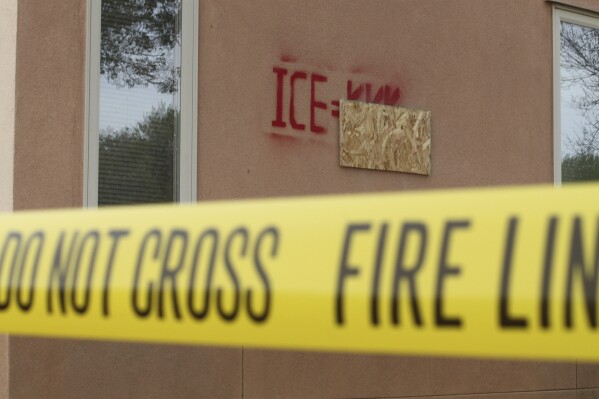 Graffiti is seen on the Republican Party of New Mexico headquarters behind yellow tape in Albuquerque, New Mexico, Monday, March 31, 2025 (AP Photo/Susan Montoya Bryan)