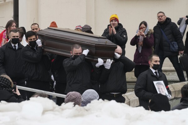 Workers carry the coffin and a portrait of Russian opposition leader Alexei Navalny out of the Church of the Icon of the Mother of God Soothe My Sorrows, in Moscow, Russia, Friday, March 1, 2024. Relatives and supporters of Alexei Navalny are bidding farewell to the opposition leader at a funeral in southeastern Moscow, following a battle with authorities over the release of his body after his still-unexplained death in an Arctic penal colony. (APPhoto)