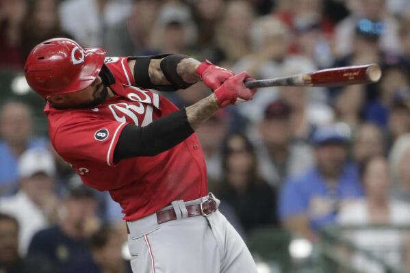 Cincinnati Reds' Nick Castellanos hits a two-run single during the ninth inning of a baseball game against the Milwaukee Brewers Sunday, July 11, 2021, in Milwaukee. (AP Photo/Aaron Gash)