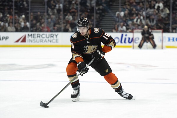 FILE - Anaheim Ducks right wing Troy Terry (19) controls the puck during the first period of an NHL hockey game against the San Jose Sharks in Anaheim, Calif., Friday, Jan. 6, 2023. All-Star forward Troy Terry agreed to a seven-year, $49 million contract extension with the Anaheim Ducks on Wednesday, Aug. 2, 2023. (AP Photo/Kyusung Gong, File)