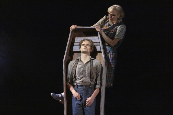 This image released by DKC/O+M shows Andrew Durand, center, with Julia Knitel, during a performance of “Dead Outlaw.