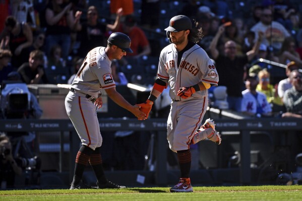 Giants open 9-run lead, hang to to beat Rockies 11-10 and stop