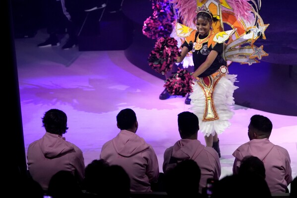 A dancer performs in front of Inter Miami soccer player Lionel Messi, second from left, seated, during an event on the world's largest cruise ship Icon of the Seas, Tuesday, Jan. 23, 2024, in Miami. The MLS soccer team Inter Miami CF has formed a partnership with the cruise line Royal Caribbean International. (AP Photo/Lynne Sladky)