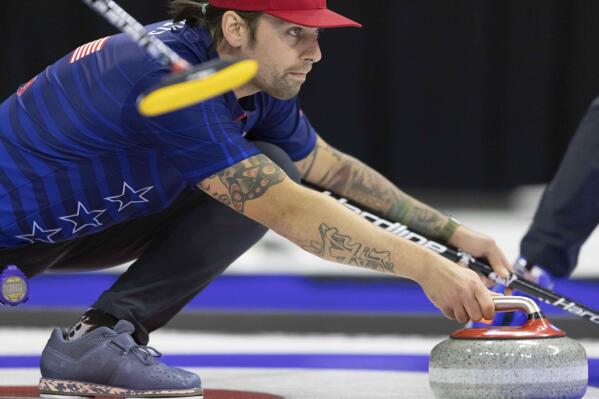 Team Shuster's Chris Plys throws the rock while competing against Team Dropkin during the second night of finals at the U.S. Olympic Curling Team Trials at Baxter Arena in Omaha, Neb., Saturday, Nov. 20, 2021. (AP Photo/Rebecca S. Gratz)