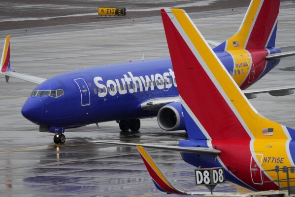 FILE - A Southwest Airlines jet arrives at Sky Harbor International Airport in Phoenix on Dec. 28, 2022. Southwest Airlines will pay a $35 million fine as part of a $140 million agreement to resolve a federal investigation into the airline's flight cancellation fiasco last December. Thousands of flights were operated over the holidays, leaving more than 2 million travelers stranded.  (AP Photo/Matt York, File)