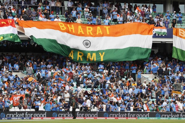 FILE- Indian national flags fly in the stands ahead of the ICC Champions Trophy match between India and South Africa in London, Sunday, June 11, 2017. Prime Minister Narendra Modi’s government has replaced India with the Sanskrit word 'Bharat' in dinner invitations sent for the Group of 20 summit, in a move that echoes with his Hindu nationalist party’s efforts to scrub away what it sees are colonial-era names. Politics over India versus Bharat has gained ground since the opposition parties in July announced a new alliance — called INDIA. (AP Photo/Kirsty Wigglesworth, File)