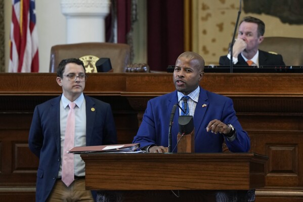 FILE - Texas Rep. Briscoe Cain, R-Baytown, left, listens as Rep. Ron Reynolds, D-Missouri City, right, debates a voting bill at the Texas Capitol in Austin, Texas, May 23, 2023. A judge on Tuesday, Aug. 15, called unconstitutional the new law passed by the GOP-led Texas Legislature that will dictate how elections are run in the state’s most populous county, which is a Democratic stronghold and home to Houston. (AP Photo/Eric Gay, File)