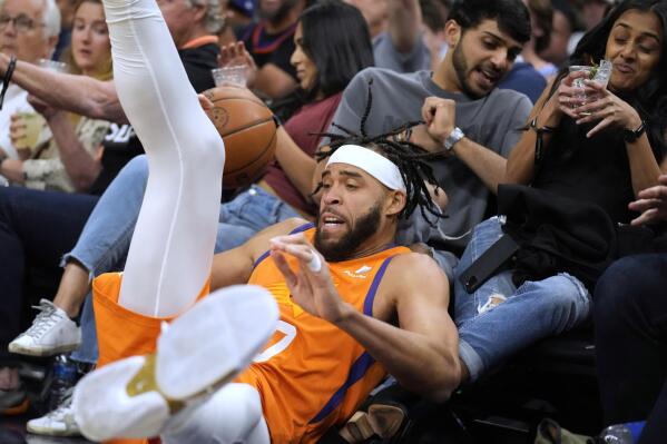 Phoenix Suns center JaVale McGee dives for the ball during the second half of the team's NBA basketball game against the Chicago Bulls, Friday, March 18, 2022, in Phoenix. Phoenix won 129-102. (AP Photo/Rick Scuteri)