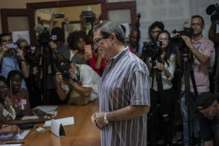 Cuba's Foreign Minister Bruno Rodriguez prepares to vote at a polling station in Havana, Cuba, Sunday, March 26, 2023. Cubans vote for the deputies that will make up the People's Power National Assembly, a unicameral parliament. (AP Photo/Ramon Espinosa)