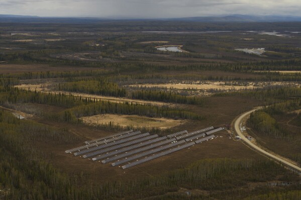 Workers install panels for a solar energy project Wednesday, May 21, 2025, in Galena, Alaska. (AP Photo/John Locher)