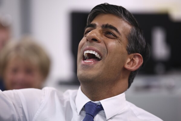 Britain's Prime Minister and Conservative Party leader Rishi Sunak, center, visits a mechanical engineering class at Cannock College, in Cannock, central England, Friday May 24, 2024, during a campaign event in the build-up to the UK general election on July 4. (Henry Nicholls/Pool via AP)