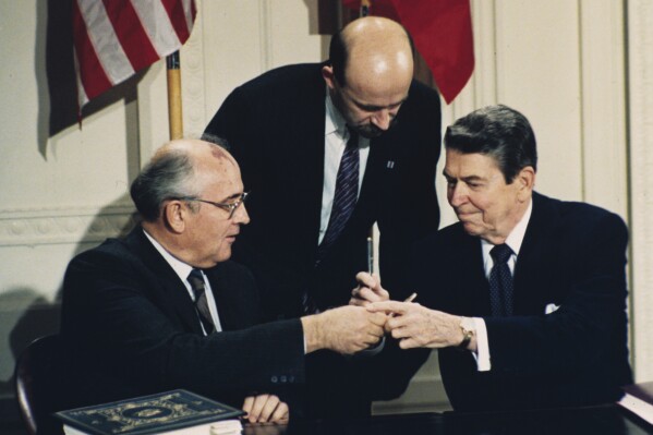 FILE - U.S. President Ronald Reagan, right, and Soviet leader Mikhail Gorbachev exchange pens at a signing ceremony of the Intermediate Range Nuclear Forces Treaty in the White House East Room in Washington, D.C., on Dec. 8, 1987. Both countries pulled out of the treaty in 2019, blaming each other for violations. On Tuesday, Nov. 7, 2023, Russia pulled out of the Treaty of Conventional Armed Forces in Europe and NATO member countries froze their participation in the pact, which was aimed at preventing the massing forces at or near their mutual borders, raising fresh questions about the future of arms control agreements in Europe. (AP Photo/Bob Daugherty, File)