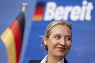 Alice Weidel, co-leader of the 'Alternative for Germany' party (AfD), smiles during a press conference at the Federal Press Office in Berlin, Germany, Oct. 9, 2023. Germany's center-right opposition won two state elections in Hesse and Bavaria on Sunday at the halfway mark of Chancellor Olaf Scholz's unpopular national government, and a far-right party that has been riding high in national polls celebrated gains. Word in the background reads 'Ready'. (Fabian Sommer/dpa via AP)