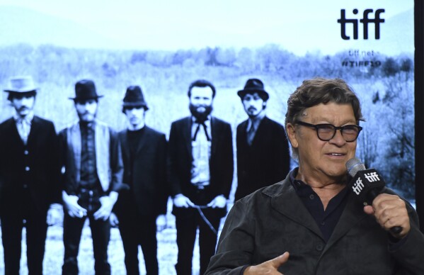 FILE - Robbie Robertson speaks during a press conference for "Once Were Brothers: Robbie Robertson and The Band" on day one of the Toronto International Film Festival on Thursday, Sept. 5, 2019, in Toronto. Robertson, the lead guitarist and songwriter for The Band, whose classics include “The Weight,” “Up on Cripple Creek” and “The Night They Drove Old Dixie Down,” has died at 80, according to a statement from his manager. (Photo by Chris Pizzello/Invision/AP, File)