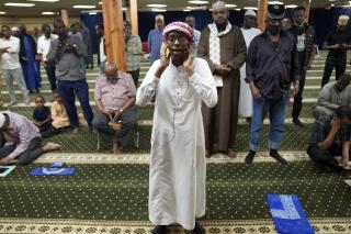 Dalha Abdi, 15, calls the adhan, or Islamic call to prayer, on Thursday, May 12, 2022, at the Abubakar As-Saddique Islamic Center in south Minneapolis. The call exhorts men to go to the closest mosque five times a day for prayer, which is one of the Five Pillars of Islam. (AP Photo/Jessie Wardarski)