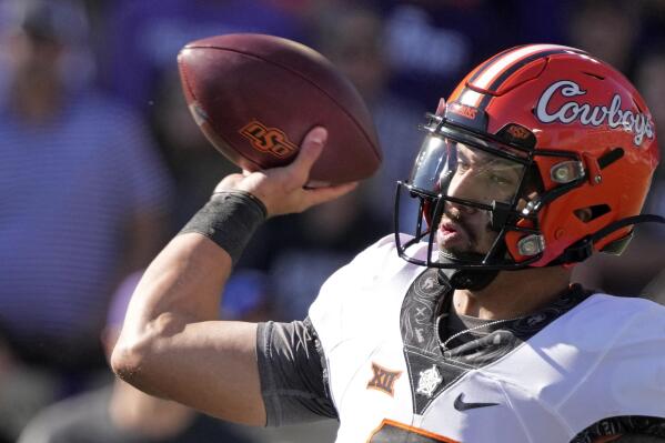 Oklahoma State quarterback Spencer Sanders throws during the first half of an NCAA college football game against Kansas State Saturday, Oct. 29, 2022, in Manhattan, Kan. (AP Photo/Charlie Riedel)