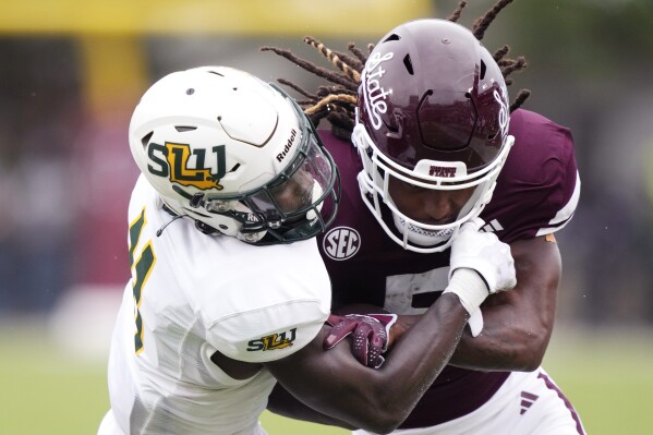 Mississippi State wide receiver Lideatrick Griffin (5) has his dreads knocked loose by a tackle by Southeastern Louisiana defensive back Kunta Hester (11) during the second half of an NCAA college football game, Saturday, Sept. 2, 2023, in Starkville, Miss. Mississippi State won 48-7. (AP Photo/Rogelio V. Solis)