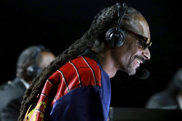 In a photo provided by Triller, Snoop Dogg performs onstage at an exhibition boxing bout between Mike Tyson and Roy Jones Jr. on Saturday, Nov. 28, 2020, in Los Angeles. The bout was unofficially ruled a draw by the WBC judges at ringside. Tyson and Jones fought eight two-minute rounds, and both emerged smiling and apparently healthy from a highly unusual event. (Joe Scarnici/Triller via AP)