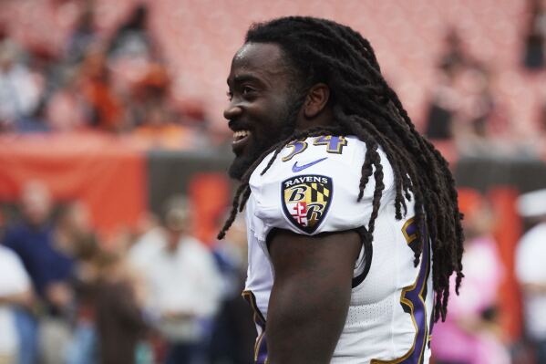 FILE - Baltimore Ravens running back Alex Collins attends during warmups prior to an NFL football game against the Cleveland Browns, Oct. 10, 2018, in Cleveland. Former NFL running back Collins, who played five seasons for the Seattle Seahawks and the Ravens after a terrific college career at Arkansas, has died. He was 28. The Seahawks released a statement from Collins' family that said he died Monday, Aug. 14, 2023. (AP Images/Rick Osentoski, File)