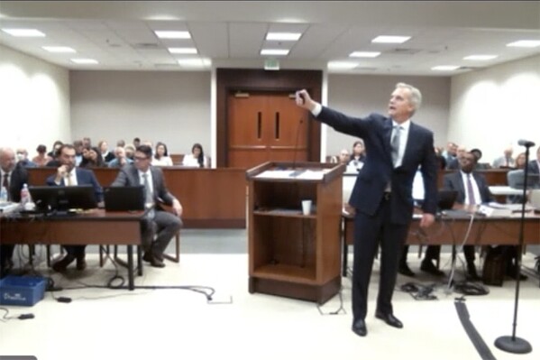 FILE - In this photo provided by the Colorado Judicial Branch, prosecutor Jonathan Bunge gives opening statements at the start of a trial of two of the police officers charged in the death of Elijah McClain, Sept. 20, 2023, in Brighton Colo. (Colorado Judicial Branch via AP, File)