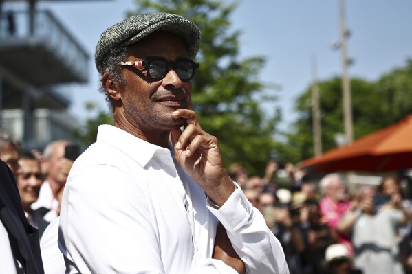 FILE - Former French tennis player Yannick Noah attends the inauguration of a fresco retracing his life, on the occasion of the 40th anniversary of his victory at Roland Garros in 1983, on day one of the Roland-Garros Open tennis tournament in Paris, May 28, 2023. Yannick Noah, the 1983 French Open champion, will take over as captain of Team Europe in the Laver Cup in 2025, replacing Bjorn Borg. The event announced Noah’s position Wednesday May 29, 2024. (Anne-Christine Poujoulat/Pool via AP, File)