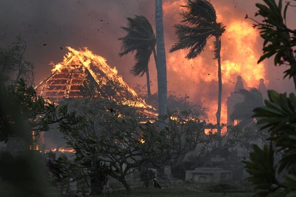 FILE - The hall of historic Waiola Church in Lahaina and nearby Lahaina Hongwanji Mission are engulfed in flames along Wainee Street on Tuesday, Aug. 8, 2023, in Lahaina, Maui, Hawaii. (Matthew Thayer/The Maui News via AP, File)