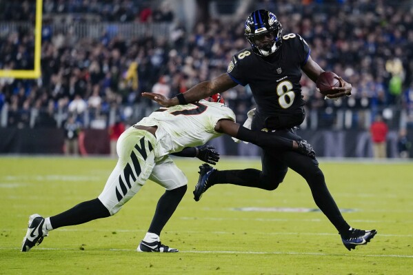 Cincinnati Bengals safety Jordan Battle (27) tackles Baltimore Ravens quarterback Lamar Jackson (8) in the second half of an NFL football game in Baltimore, Thursday, Nov. 16, 2023. (AP Photo/Matt Rourke)