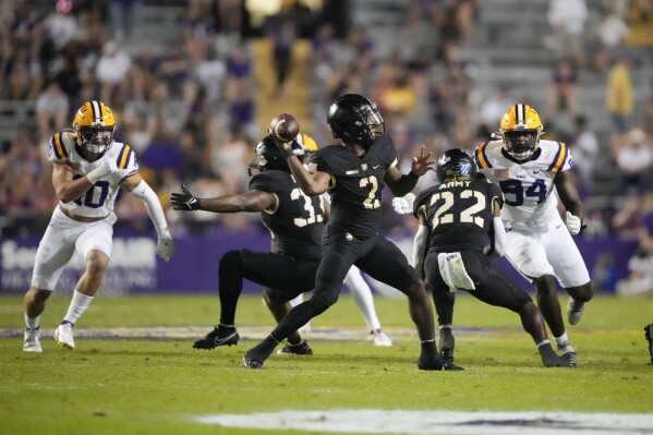 Army quarterback Larry Robinson (2) passes in the second half of an NCAA college football game against LSU in Baton Rouge, La., Saturday, Oct. 21, 2023. LSU won 62-0. (AP Photo/Gerald Herbert)