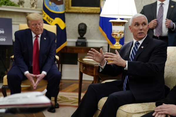 President Donald Trump listens as Vice President Mike Pence speaks during a meeting about the coronavirus with Louisiana Gov. John Bel Edwards, not pictured, in the Oval Office of the White House, Wednesday, April 29, 2020, in Washington. (AP Photo/Evan Vucci)