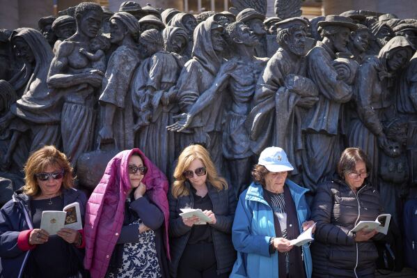 Faithful listen to mass during the funeral of Pope Francis in St. Peter's Square at the Vatican, Saturday, April 26, 2025. (AP Photo/Emilio Morenatti)