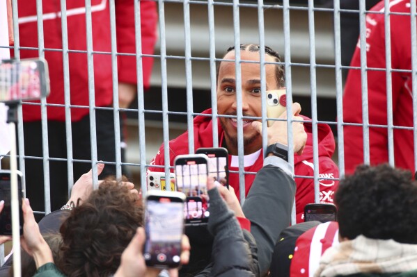 Ferrari driver Lewis Hamilton meet fans after testing the new Ferrari SF-25 at Fiorano circuit, near Maranello, Italy, Wednesday Feb. 19, 2025. (Davide Gennari/LaPresse via AP)