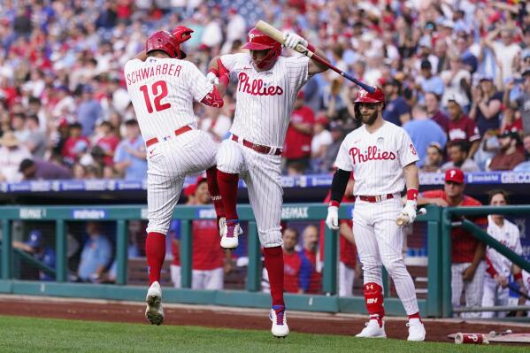 Philadelphia Phillies' Rhys Hoskins, center, and Kyle Schwarber, left, celebrate after Schwarber's home run during the first inning of a baseball game against the Los Angeles Angels, Friday, June 3, 2022, in Philadelphia. (AP Photo/Matt Slocum)