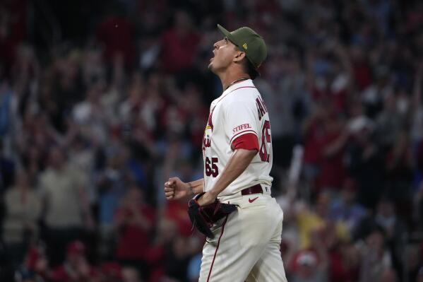 Nolan Gorman of the St. Louis Cardinals raises his bat as he runs