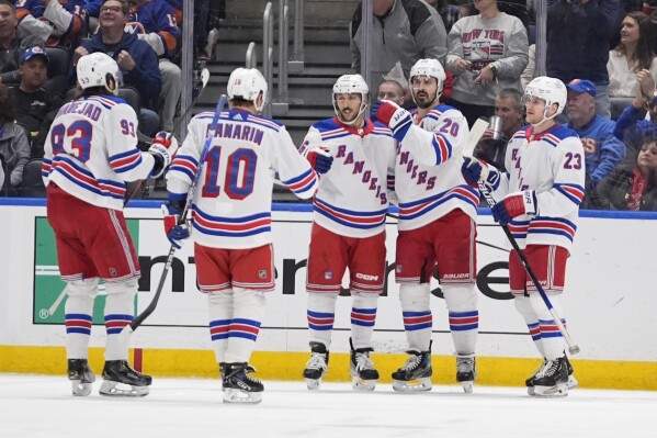 New York Rangers' Chris Kreider (20) celebrates with Vincent Trocheck (16), Adam Fox (23), Artemi Panarin (10) and Mika Zibanejad (93) after scoring a goal against the New York Islanders during the second period of an NHL hockey game Tuesday, April 9, 2024, in Elmont, N.Y. (AP Photo/Frank Franklin II)