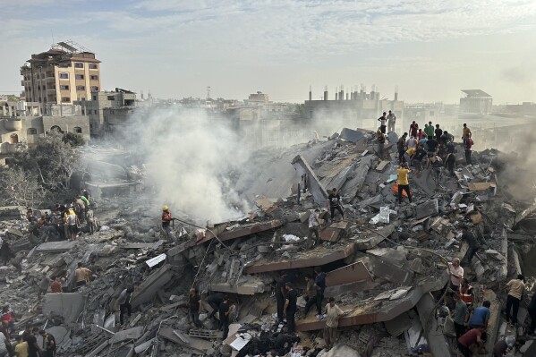 Palestinians look for survivors following Israeli airstrike in Nusseirat refugee camp, Gaza Strip, Tuesday, Oct. 31, 2023. (AP Photo/Doaa AlBaz)