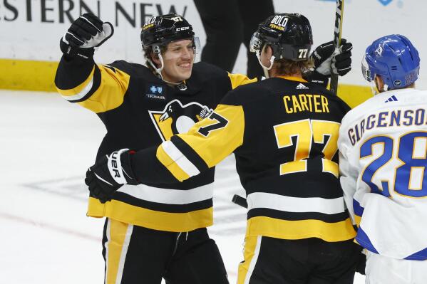 Pittsburgh Penguins center Jeff Carter (77) celebrates after his winning goal with right winger Rickard Rakell (67) during the overtime period of an NHL hockey game against the Buffalo Sabres, Friday, Dec. 9, 2022, in Buffalo, N.Y. (AP Photo/Jeffrey T. Barnes)