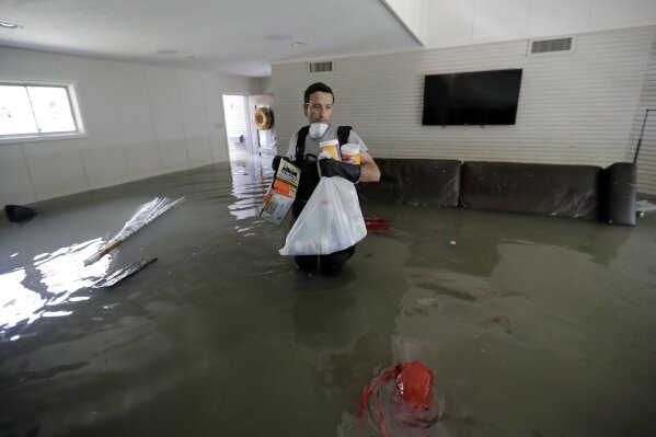 
              Gaston Kirby walks through floodwater inside his home in the aftermath of Harvey, Monday, Sept. 4, 2017, near the Addicks and Barker Reservoirs, in Houston. (AP Photo/David J. Phillip)
            