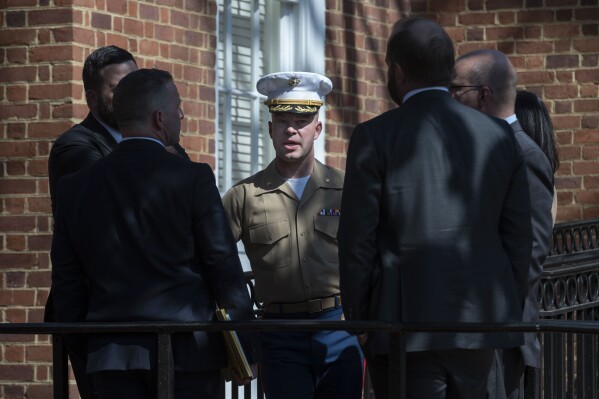 FILE - U.S. Marine Corp Major Joshua Mast, center, talks with his attorneys during a break in the hearing in an ongoing custody battle over an Afghan orphan, at the Circuit Courthouse in Charlottesville, Va., Thursday, March 30, 2023. The Marine insists that the Afghan baby pulled from the rubble after a 2019 night raid is the stateless orphan of militants, and convinced a rural Virginia state court judge to grant him an adoption from 7,000 miles away. (AP Photo/Cliff Owen, File)