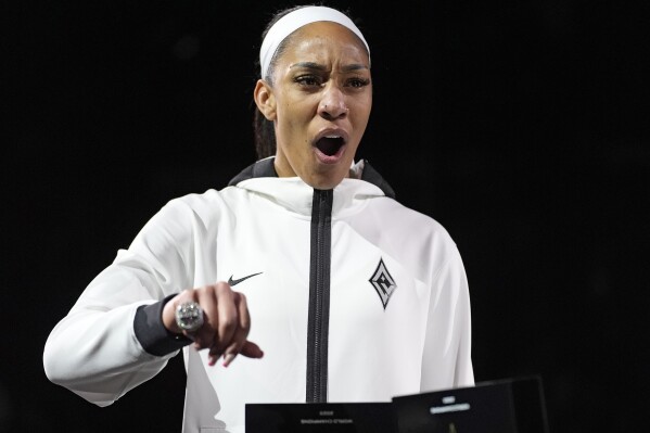 Las Vegas Aces center A'ja Wilson (22) reacts as she wears the 2023 championship ring before a WNBA basketball game Tuesday, May 14, 2024, in Las Vegas. (AP Photo/John Locher)
