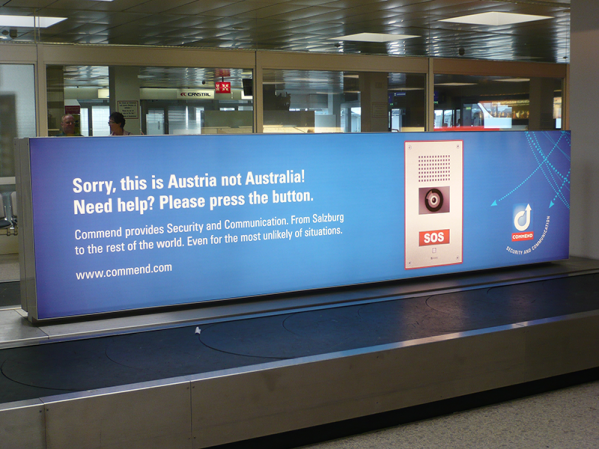 This photo provided by Commend International shows an advertisement for the technology company at Salzburg Airport in Austria. (Commend International/Salzburg Airport via AP)