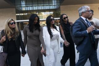 FILE - Vanessa Bryant, center, Kobe Bryant's widow, leaves a federal courthouse with her daughter Natalia, center left, soccer player Sydney Leroux, center right, in Los Angeles, Wednesday, Aug. 24, 2022. The family of the late Kobe Bryant has agreed to a $28.5 million settlement with Los Angeles County to resolve the remaining claims in a lawsuit over deputies and firefighters sharing grisly photos of the NBA star, his 13-year-old daughter and other victims killed in a 2020 helicopter crash, attorneys and court filings said Tuesday, Feb. 28, 2023. (AP Photo/Jae C. Hong, File)