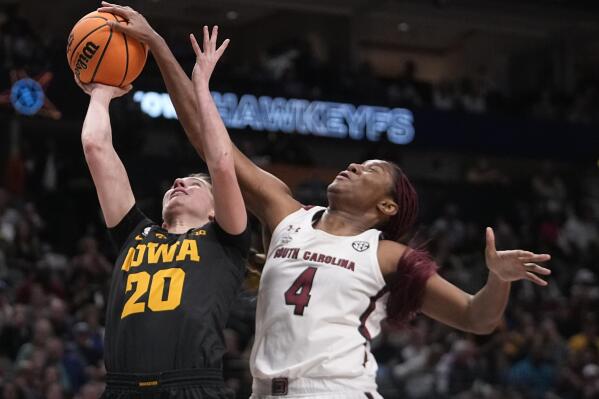 Iowa's Kate Martin tries to shoot past South Carolina's Aliyah Boston during the first half of an NCAA Women's Final Four semifinals basketball game Friday, March 31, 2023, in Dallas. (AP Photo/Darron Cummings)
