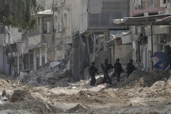 Members of Israeli forces patrol a street during a military operation in the West Bank refugee camp of Nur Shams, Tulkarem, Thursday, Aug. 29, 2024. (AP Photo/Majdi Mohammed)