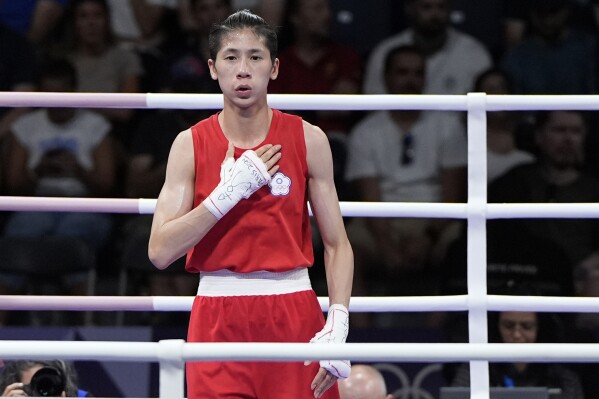 Taiwan's Lin Yu-ting reacts after defeating Uzbekistan's Sitora Turdibekova in their women's 57 kg preliminary boxing match at the 2024 Summer Olympics, Friday, Aug. 2, 2024, in Paris, France. (AP Photo/John Locher)