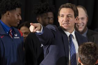 Florida Governor Ron DeSantis takes questions from the media during a press conference at Christopher Columbus High School on Monday, March 27, 2023, in Miami, Fla. The press conference was held to announce DeSantis's signing of a private school voucher expansion, HB1, which allows more Florida school children become eligible for taxpayer-funded school vouchers.(Matias J. Ocner/Miami Herald via AP)