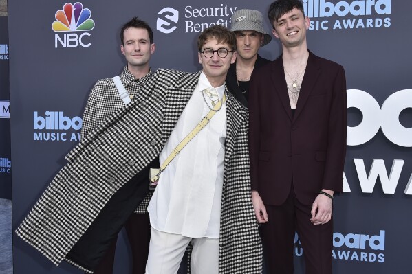 FILE - Drew MacFarlane, from left, Dave Bayley, Joe Seaward and Edmund Irwin-Singer of Glass Animals arrive at the Billboard Music Awards on Sunday, May 15, 2022, at the MGM Grand Garden Arena in Las Vegas. The English indie-pop band releases its fourth album on July 19. (Photo by Jordan Strauss/Invision/AP, File)