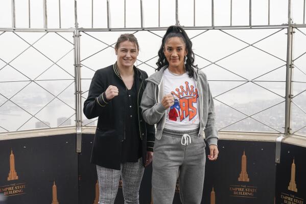 Boxers Amanda Serrano, right, and Katie Taylor pose for pictures on the observation deck of the Empire State Building in New York, Tuesday, April 26, 2022. Taylor and Serrano will become the first two female fighters to headline a boxing match at Madison Square Garden when they fight on Saturday for the World Lightweight title. (AP Photo/Seth Wenig)