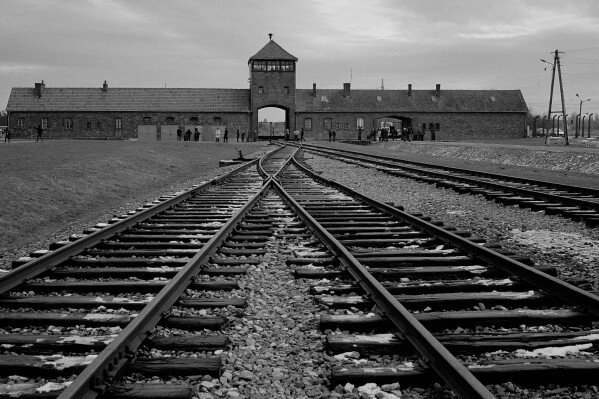 FILE - The railway tracks where hundred thousands of people arrived to be directed to the gas chambers inside the former Nazi death camp of Auschwitz Birkenau, or Auschwitz II, are pictured in Oswiecim, Poland, Saturday, Dec. 7, 2019. Almost 80 years after the Holocaust, about 245,000 Jewish survivors are still living across more than 90 countries, according to the report by the New York-based Conference on Jewish Material Claims Against Germany. (AP Photo/Markus Schreiber, File)